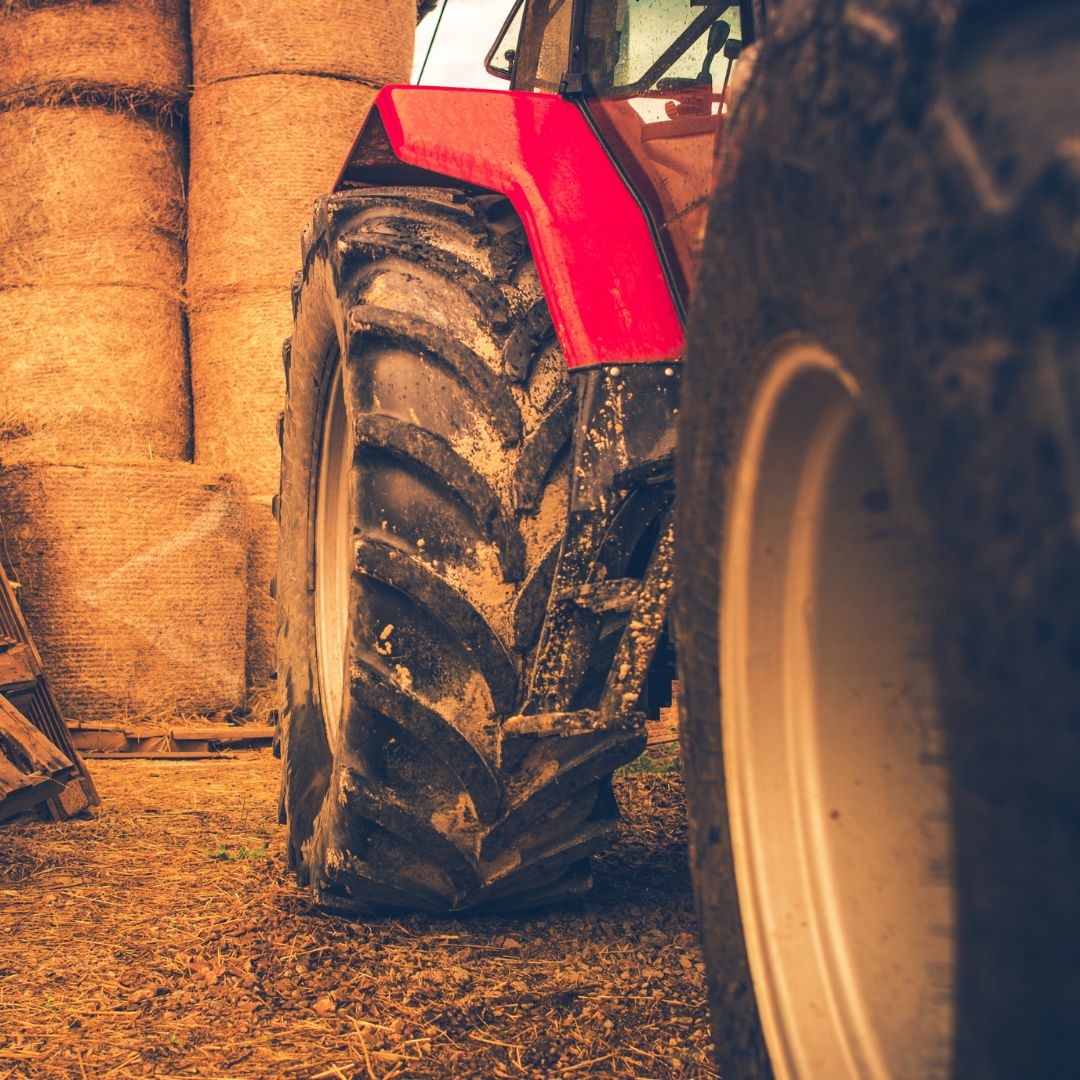 Red hay baler in storage.