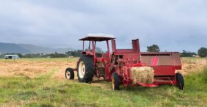 A red baler on a field
