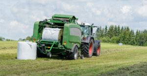 The back of a green baler on a field