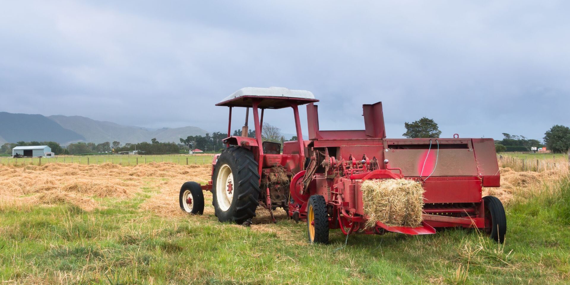 A red baler on a field